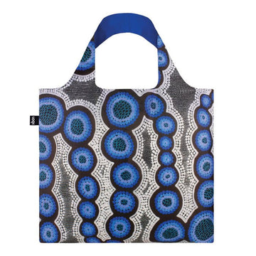 A tote bag in blue and grey printed with artwork by Kirsten Nangala Egan.