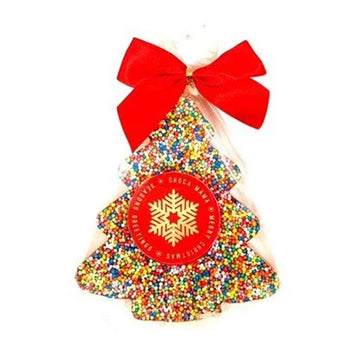 A Christmas tree shaped chocolate covered with sprinkles and wrapped in plastic with a red bow.