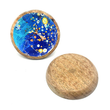 A wooden round trinket dish is pictured twice, one showing the patterned inside with artwork by Stephen Jupurrula Nelson and the other upside down showing the base.