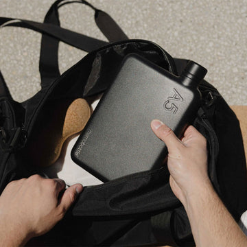 A flat black stainless steel bottle in an A5 shape with 'A5' engraved in the top right corner.