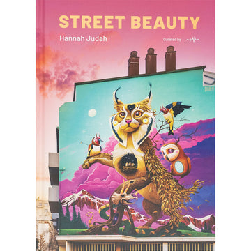 'Street Beauty' book cover featuring artwork with a cat like face and a tree like body with birds in the trees against a colourful mountain background.