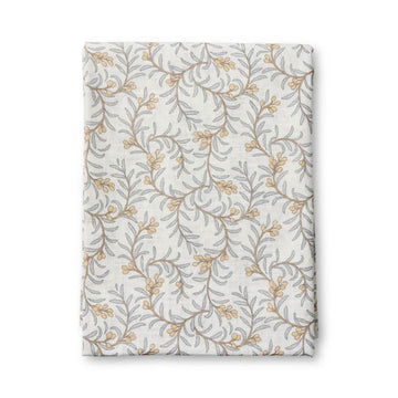 Floral patterned table cloth folded up on a white background.