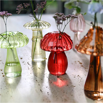 Five colorful glass mushroom-shaped objects on a white background.