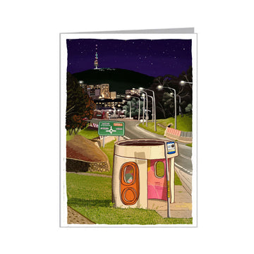 Greeting card with a stylized illustration of a road at night with streetlights and a bus shelter.