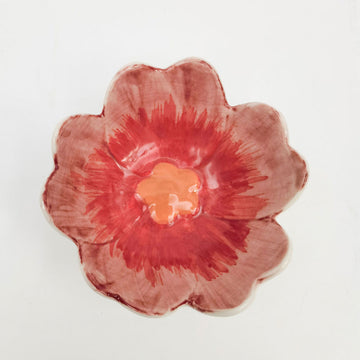 Top down view of a small ceramic bowl shaped like a pink flower.