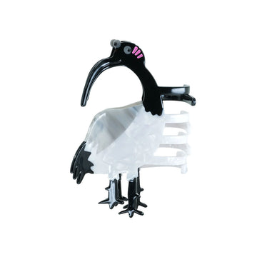 Bird-shaped hair clip with black beak and white body on a white background.
