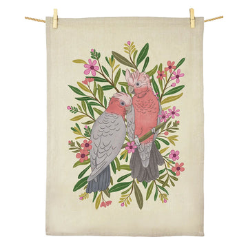 Tea towel with two illustrated galahs on a beige background.