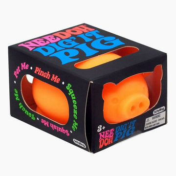 A pig shaped stress ball in orange inside a box with cut outs and the text 'Nee Doh Dig It Pig' on the top.