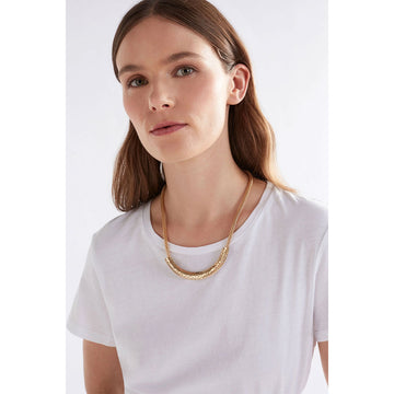 A gold mesh chain necklace with a long gold bar across the front with small circle cut outs.