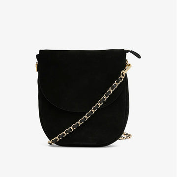 A black suede bag with a tall round shape and a gold chain strap.