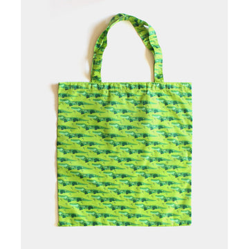 A reusable shopping bag in light green illustrated with a repeat pattern of crocodiles.