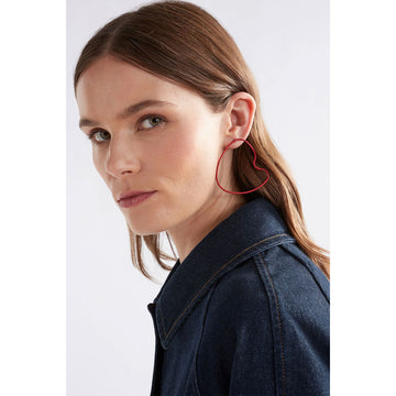 A pair of stud earrings with a large outline in black in an irregular shape.