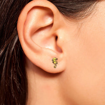 A pair of dragon shaped gold stud earrings.