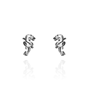 A pair of silver dragon shaped stud earrings.