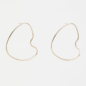 A pair of stud earrings with a large outline in gold in an irregular shape.