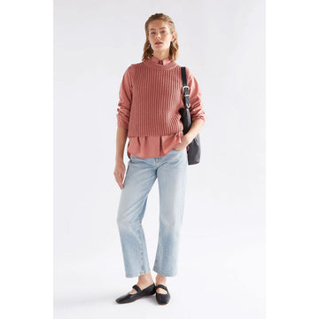 Pink knitted sleeveless top on a white background.