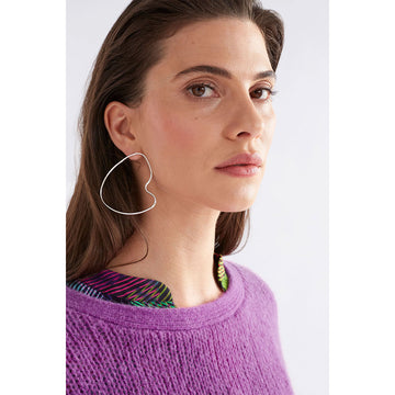 A pair of stud earrings with a large outline in silver in an irregular shape.