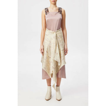 A silk scarf is being worn around the waist of a model wearing a pink dress and cream coloured boots.