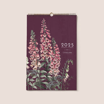 Front view of a spiral bound calendar with an illustration of pink flowers on a purple background.