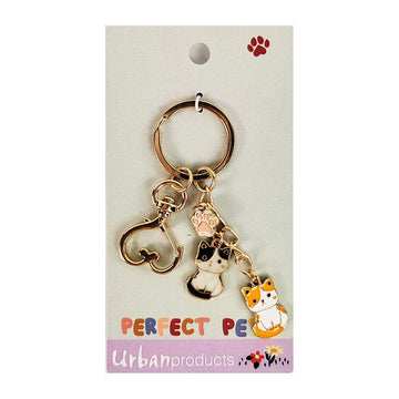A kerying with two cat charms and a paw print charm attached to a card with the heading 'Perfect Pets'.