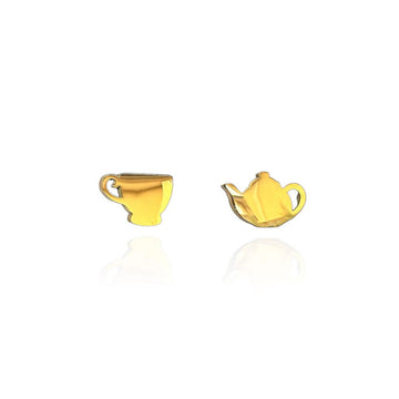 A pair of gold stud earrings with one earring shaped like a tea cup and the other shaped like a tea pot.