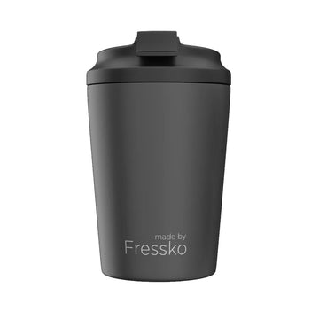 A ceramic reusable coffee cup in dark grey with a black lid and the text 'made by Fressko' along the bottom.