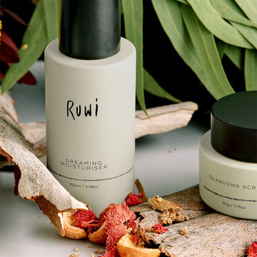 Moisturizer bottle with 'Ruwi' branding on a marble surface.