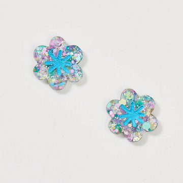 A pair of stud earrings shaped like a flower in a blue and purple glitter design.