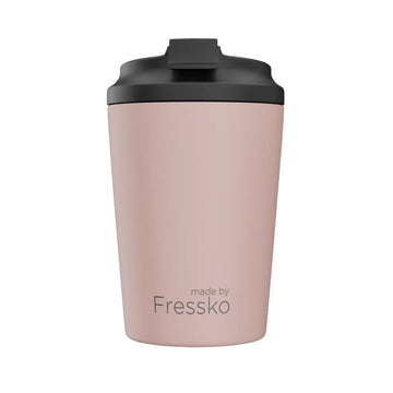A ceramic reusable coffee cup in dusty pink with a black lid and the text 'made by Fressko' on the front.