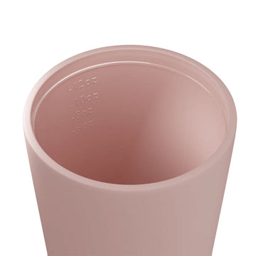 A ceramic reusable coffee cup in dusty pink with a black lid and the text 'made by Fressko' on the front.