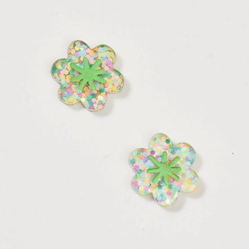 A pair of stud earrings shaped like a flower in a green and pink glitter design.