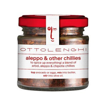 A jar filled with chilli spices with a white product label around the jar and a red lid.