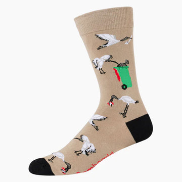 A pair of light brown socks with a black heel and toe and illustrated with ibis birds.