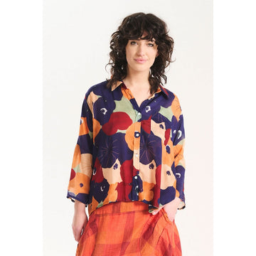 A women's shirt printed with a colourful floral design.