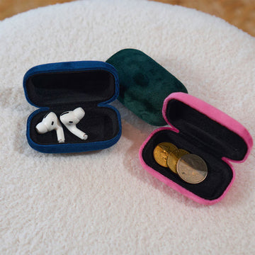 A small hard shell case in green velvet.