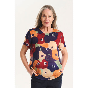 A women's short sleeve top printed with a colourful floral design.