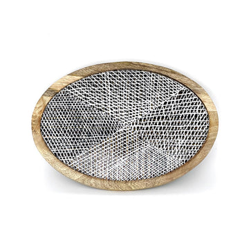 Round wooden tray with a geometric black and white design on a white background.