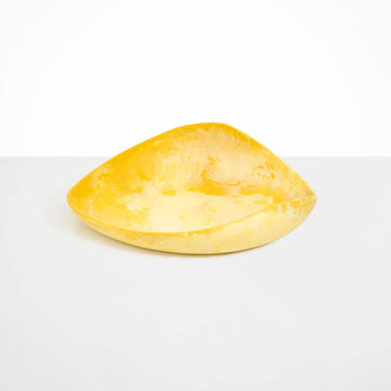 A large resin bowl shaped like a leaf in yellow.