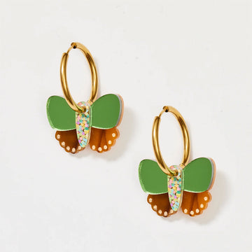 A pair of gold hoop earrings with green and bronze butterflies attached to the hoops.