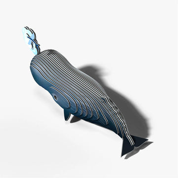 Model of a whale blowing water with a small fish nearby on a white background.