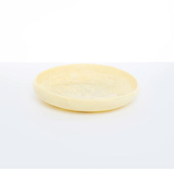 A shallow bowl made from resin with pale yellow and white swirls.