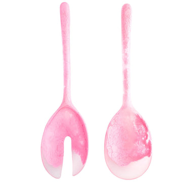 A pair of pink salad servers made from resin.