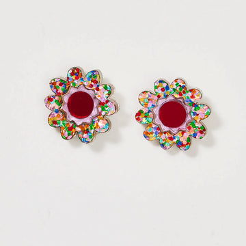 A pair of floral stud earrings with a red centre and glitter edges.