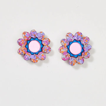 A pair of floral stud earrings with a pink centre and glitter edges.