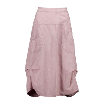 A linen skirt in baby pink with side pockets and a tuck on either side.