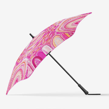 A pink umbrella standing on its side and printed with artwork by Kenita Lee.