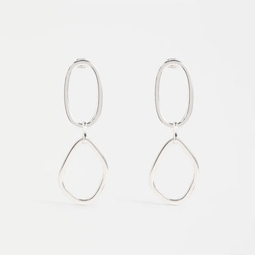 Silver hoop earrings on a light gray background.