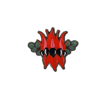 A metal badge shaped like a Sturt Pea flower.
