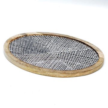 Round wooden tray with a geometric black and white design on a white background.