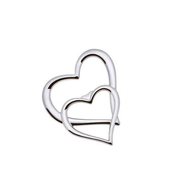 A bottle opener in chrome shaped like two hearts overlapping.
